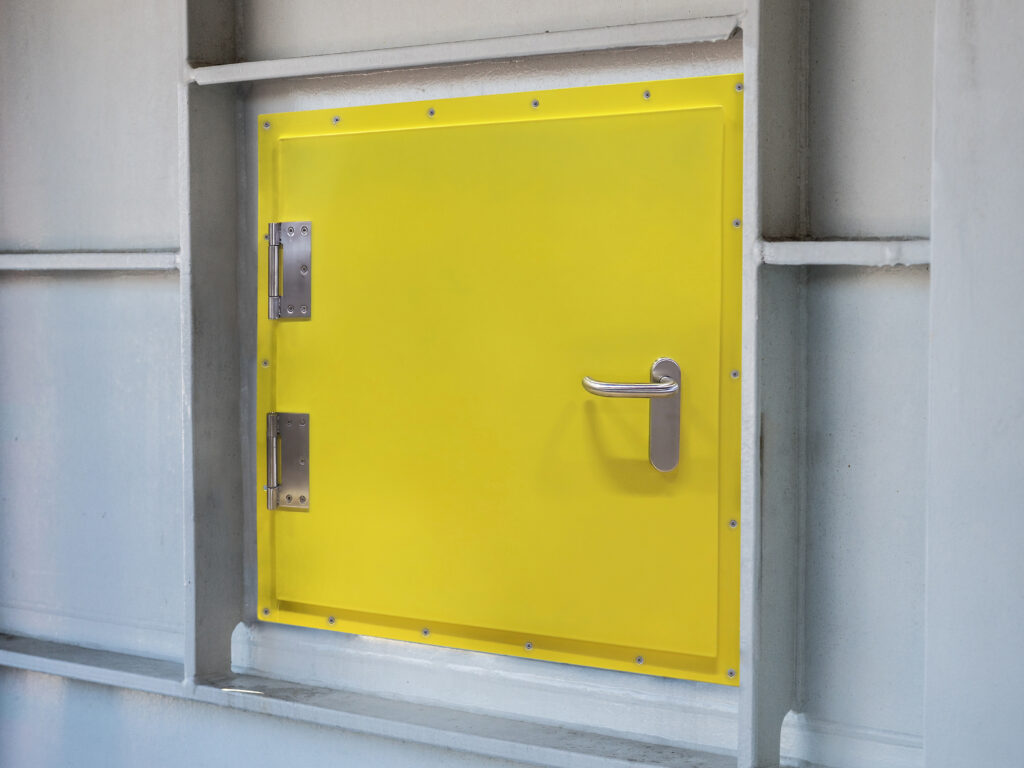 White metal ship hatch door with industrial locking mechanisms and hinges
